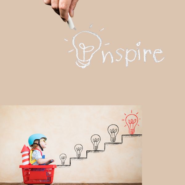 Child in cart peering up steps with hand drawn light bulbs on each step leading up to handwritten word inspire with a light bulb.